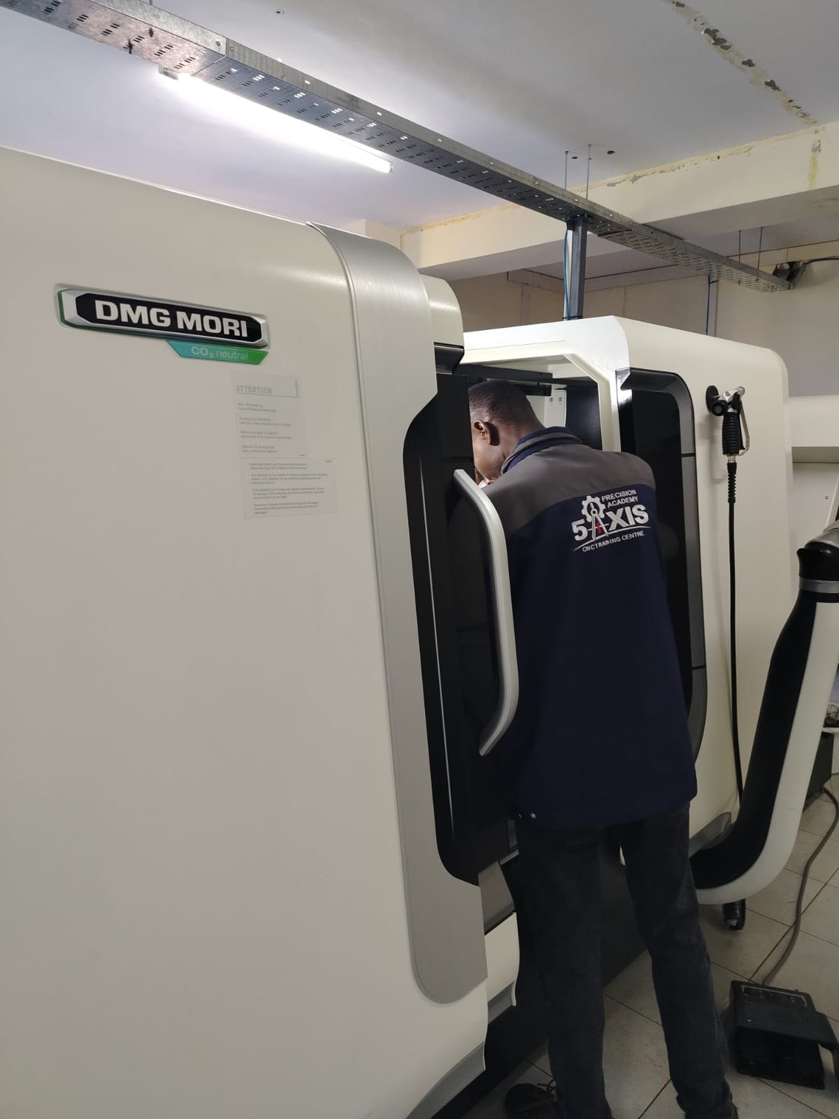 Trainee working at a CNC control panel